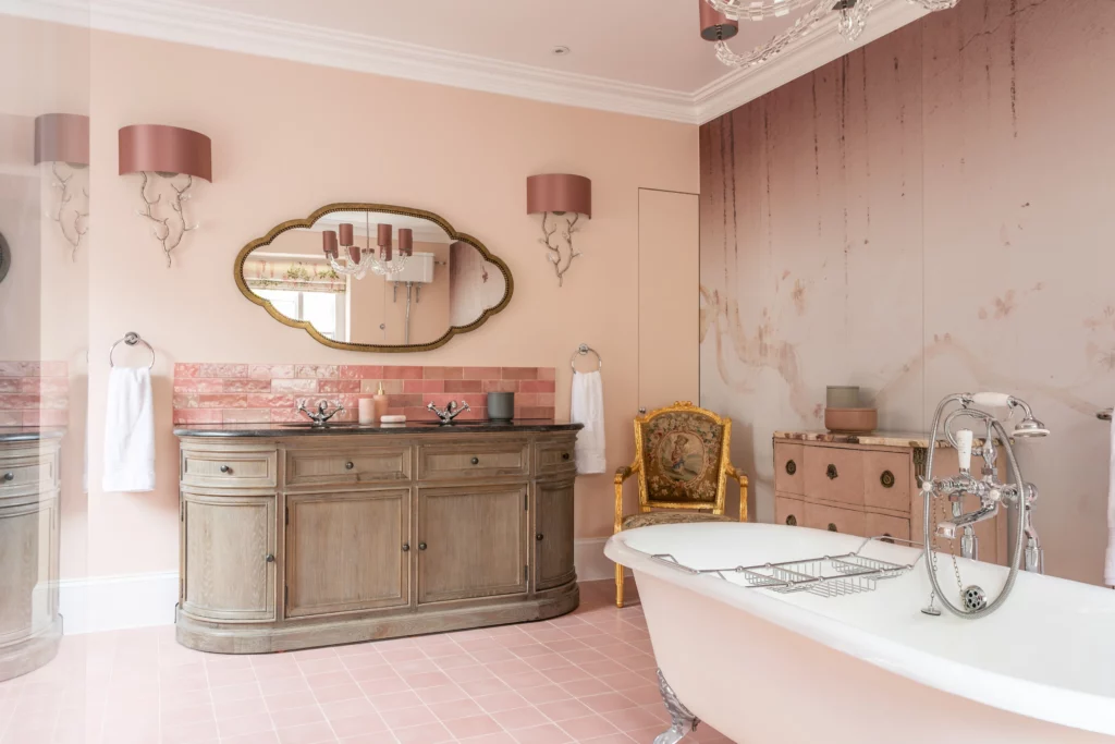 Pink bathroom with roll top bath